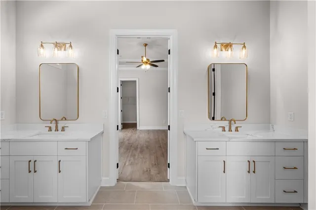 a bathroom with double vanity sink and a mirror