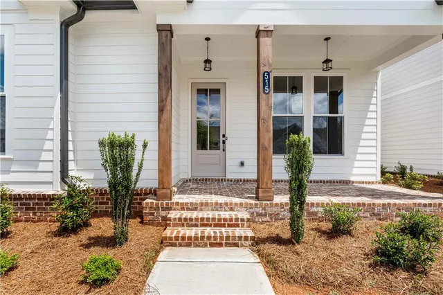 a front view of a house with a garden
