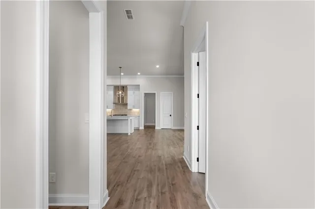 a view of a kitchen with wooden floor and a sink