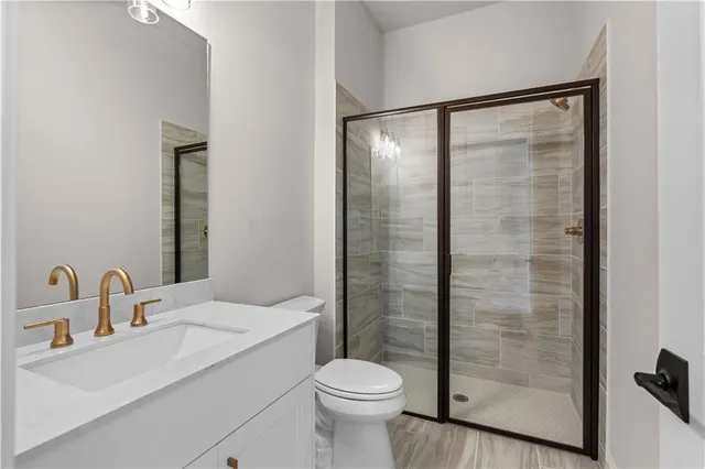 a bathroom with a sink toilet and shower