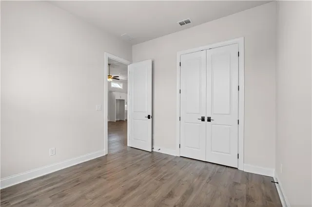 a view of an empty room and wooden floor