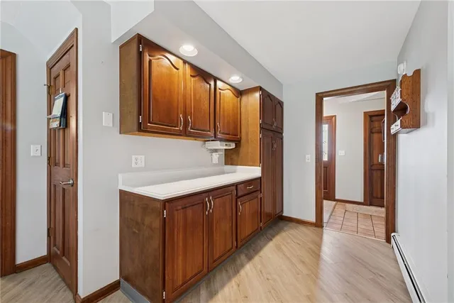 a kitchen with a sink cabinets and wooden floor