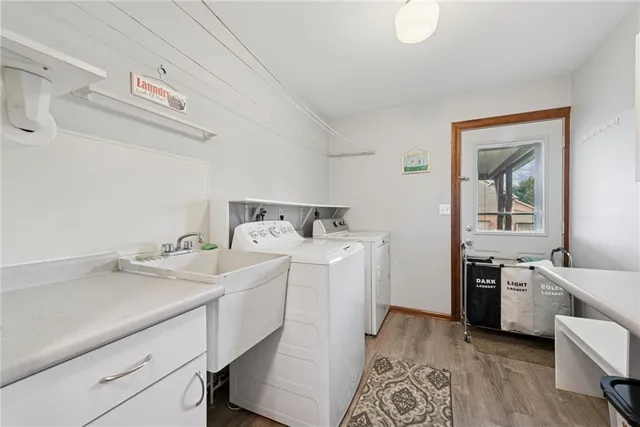 a utility room with sink dryer and washer