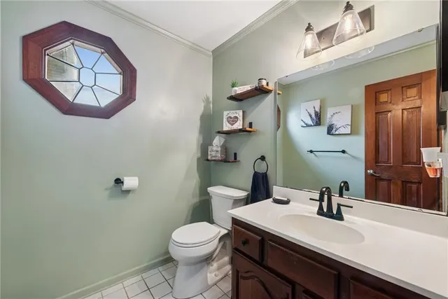 a bathroom with a toilet a sink and mirror