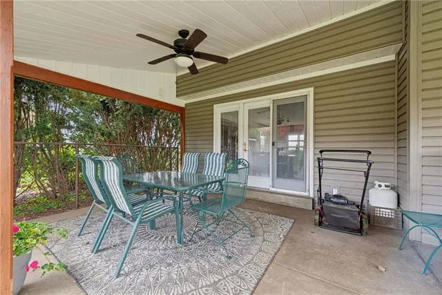 a view of a porch with furniture and a yard