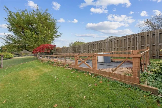 a view of a garden with wooden fence