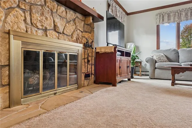 a view of a house with a barbeque and wooden stairs