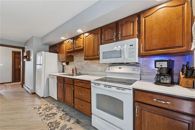a kitchen with stainless steel appliances granite countertop a refrigerator sink and cabinets