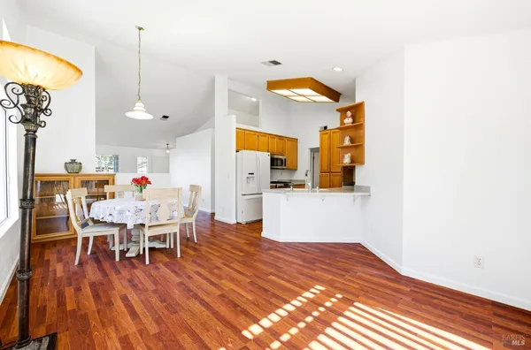 a dining room with furniture and wooden floor
