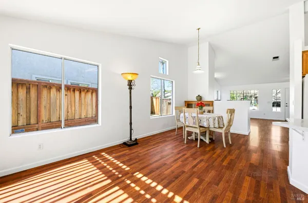 a dining room with furniture and wooden floor