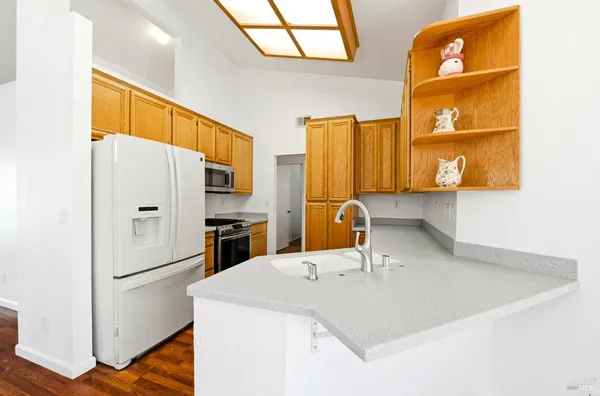 a kitchen with a sink cabinets and refrigerator