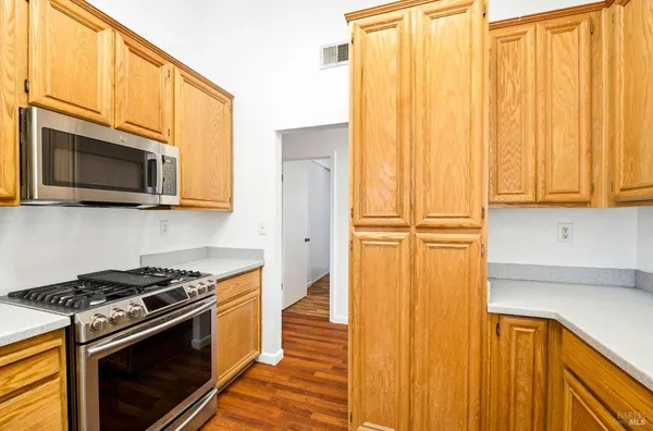 a kitchen with a stove microwave and cabinets
