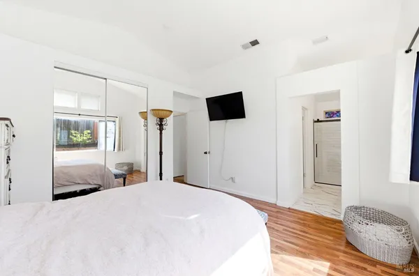 a bedroom with a bed and a flat screen tv