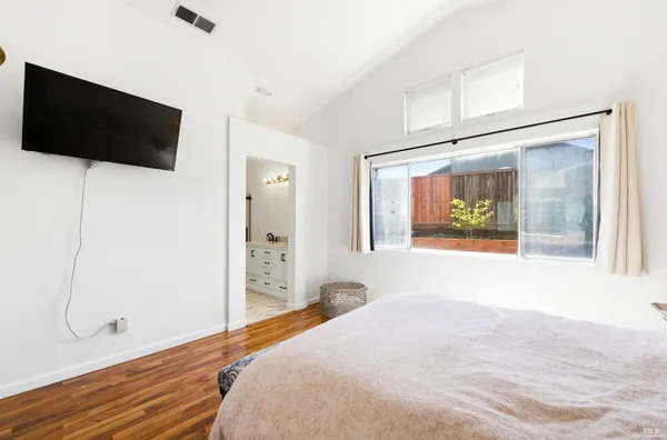 a bedroom with a bed and a flat screen tv