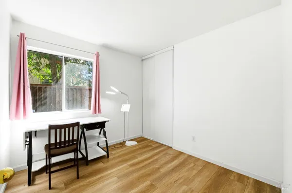 a view of a room with wooden floor and chair