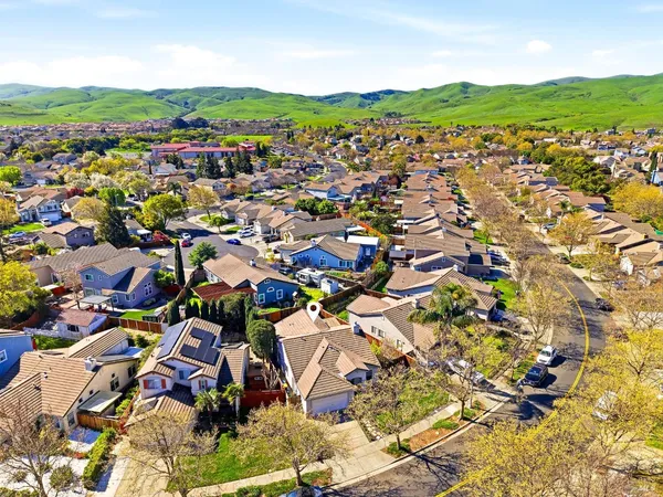 an aerial view of a house with a yard and furniture