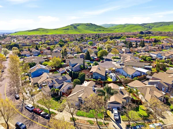 an aerial view of multiple houses with yard