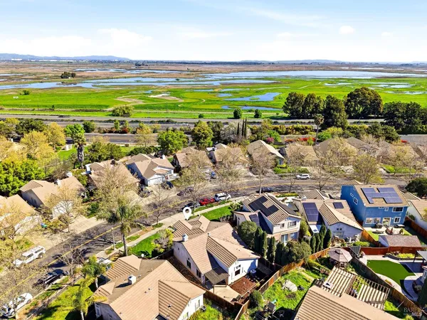 an aerial view of residential houses with outdoor space