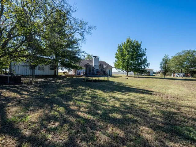 a backyard of a house with lots of green space