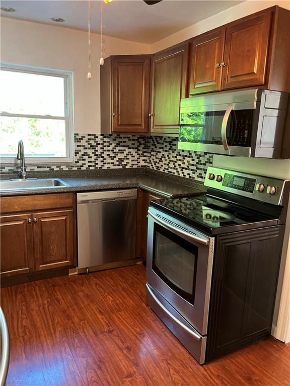 300 Highland Road Pittsburgh, PA 15235 - Photo 12 of 40 a kitchen with stainless steel appliances a stove a sink and a microwave