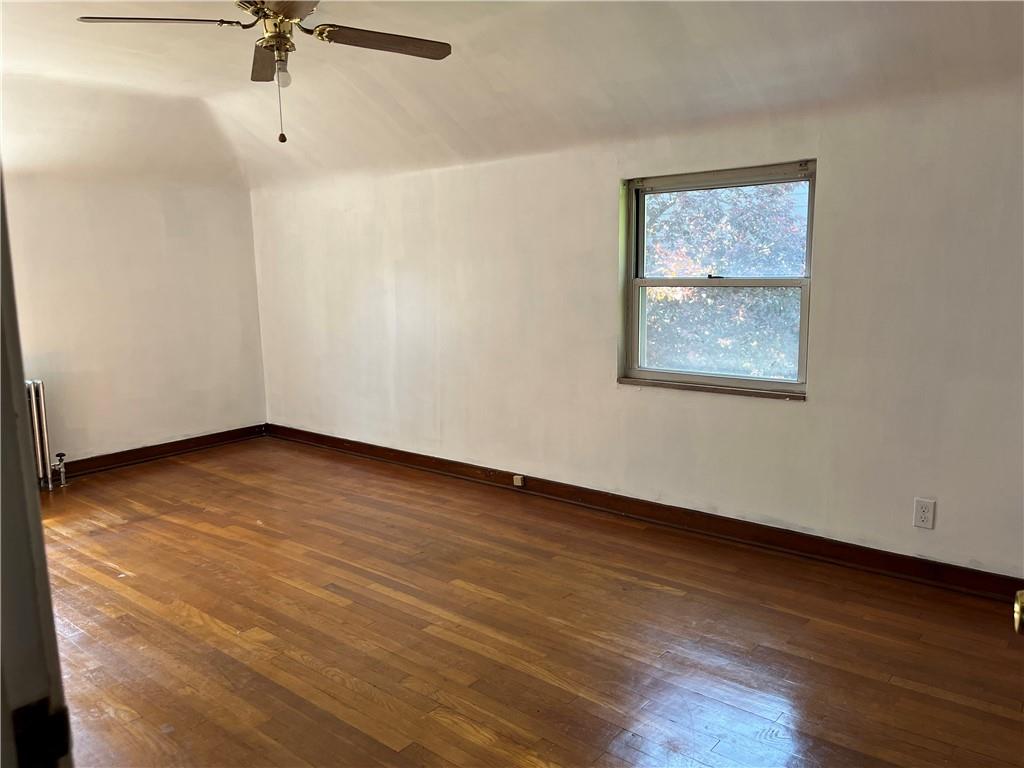 300 Highland Road Pittsburgh, PA 15235 - Photo 26 of 40 a view of an empty room with a window and wooden floor