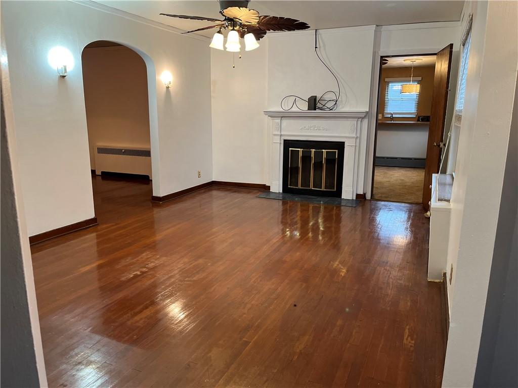 300 Highland Road Pittsburgh, PA 15235 - Photo 3 of 40 an empty room with wooden floor fireplace and windows