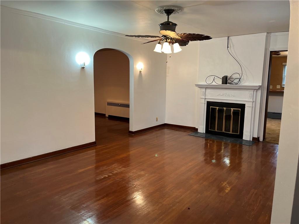 300 Highland Road Pittsburgh, PA 15235 - Photo 4 of 40 an empty room with wooden floor fireplace and windows