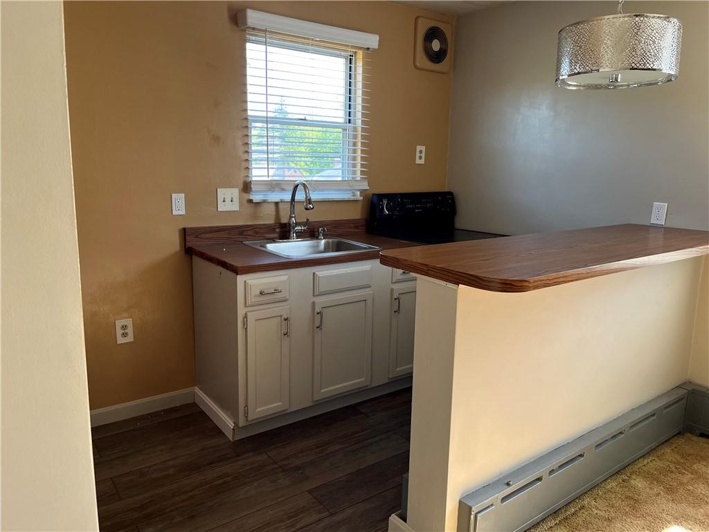 300 Highland Road Pittsburgh, PA 15235 - Photo 9 of 40 a kitchen with a sink and wooden floor