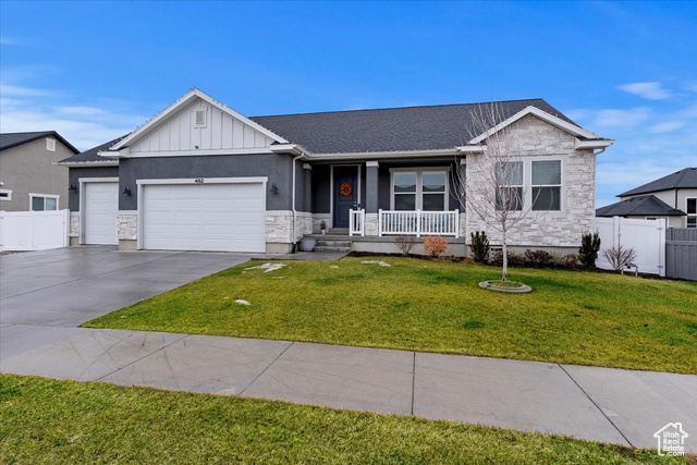 482 East Mount Dutton Way Eagle Mountain, UT 84005 - Photo 1 of 1 View of front facade featuring a front yard, a garage, and a porch