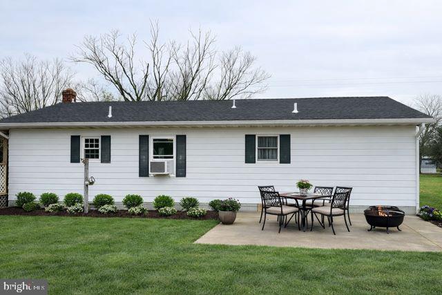 31348 Mt Pleasant Road Laurel, DE 19956 - Photo 8 of 10 a view of a backyard with table and chairs potted plants and a wooden fence