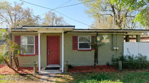 a view of a house with a tree