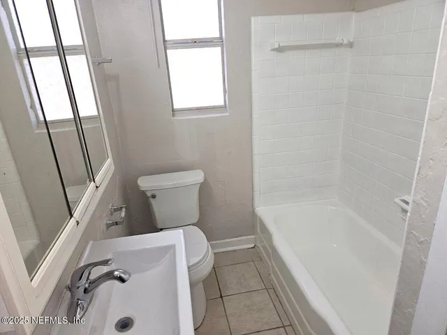a bathroom with a toilet and a bathtub