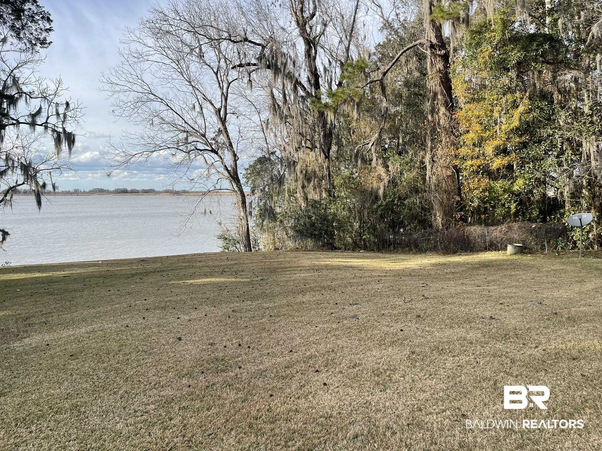 6621 Purvis Road Daphne, AL 36527 - Photo 50 of 59 View of green lawn featuring a water view