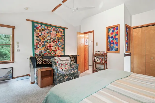 a bed room with a bed and a chair