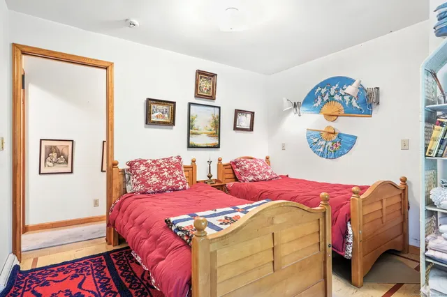 a bedroom with a bed and a painting on the wall