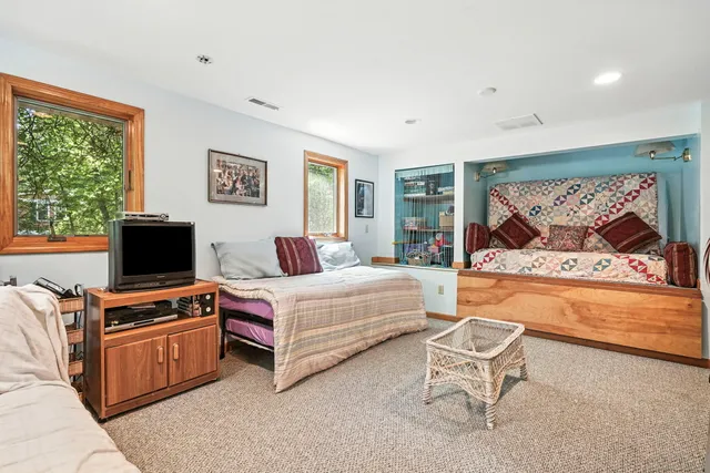 a bedroom with furniture and a flat screen tv