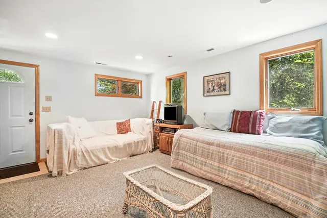 a bedroom with two beds and a large window