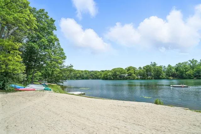 an aerial view of a houses with a yard and lake view