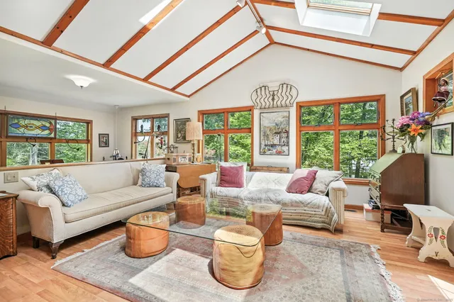 a living room with patio furniture and a large window