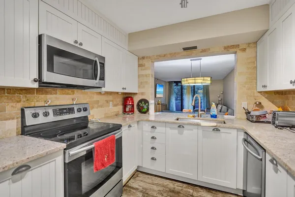 a kitchen with a stove and a microwave