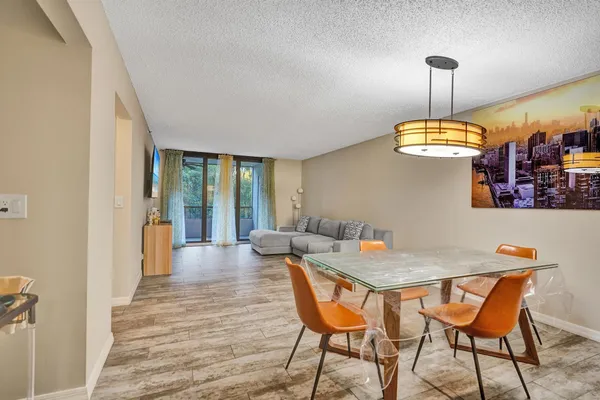 a view of a dining room with furniture wooden floor and chandelier