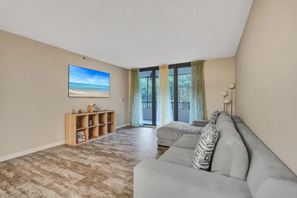 a living room with furniture window and a flat screen tv