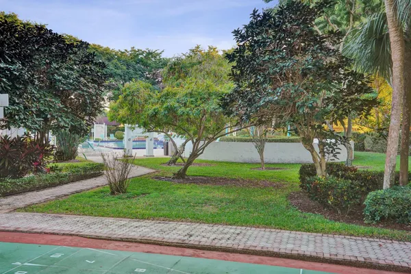 a front view of a house with a yard and tree s