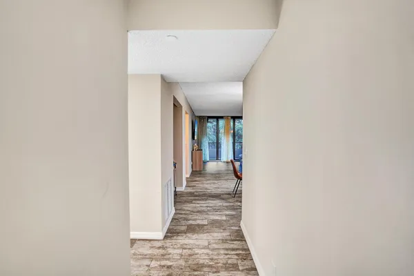 a view of a hallway with wooden floor and staircase