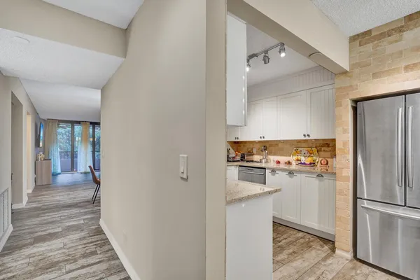 a kitchen with a refrigerator and cabinets