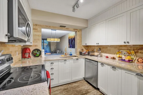 a kitchen with a sink stove and cabinets