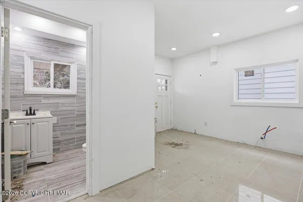 a bathroom with a toilet a sink and mirror
