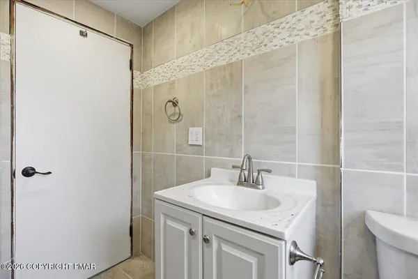 a view of a brick house with wooden fence