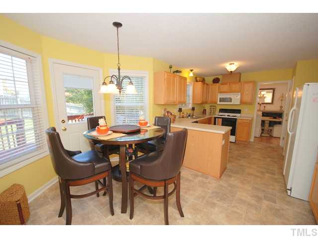 4105 Mantua Way Raleigh, NC 27604 - Photo 11 of 25 a dining room with furniture and a chandelier