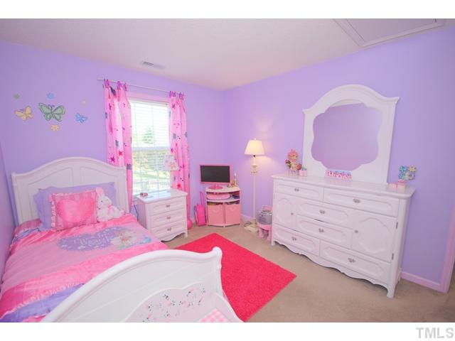 4105 Mantua Way Raleigh, NC 27604 - Photo 18 of 25 a bedroom with a bed and a dresser